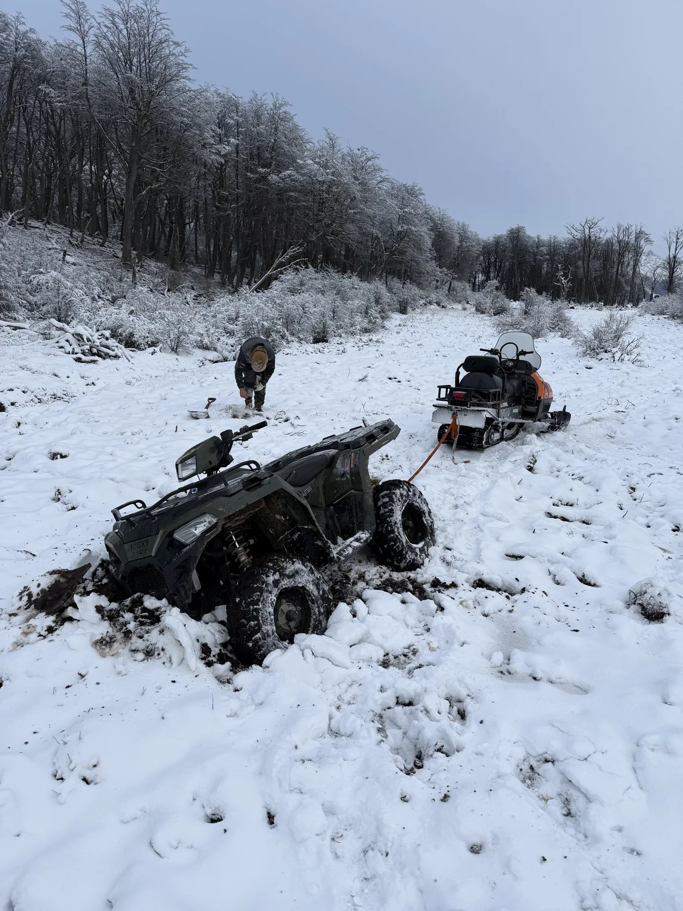 ATV and snowmobile in winter terrain